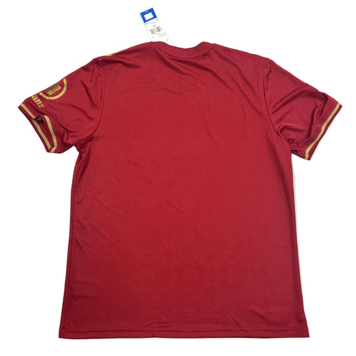 Red t-shirt with gold accents on a white surface