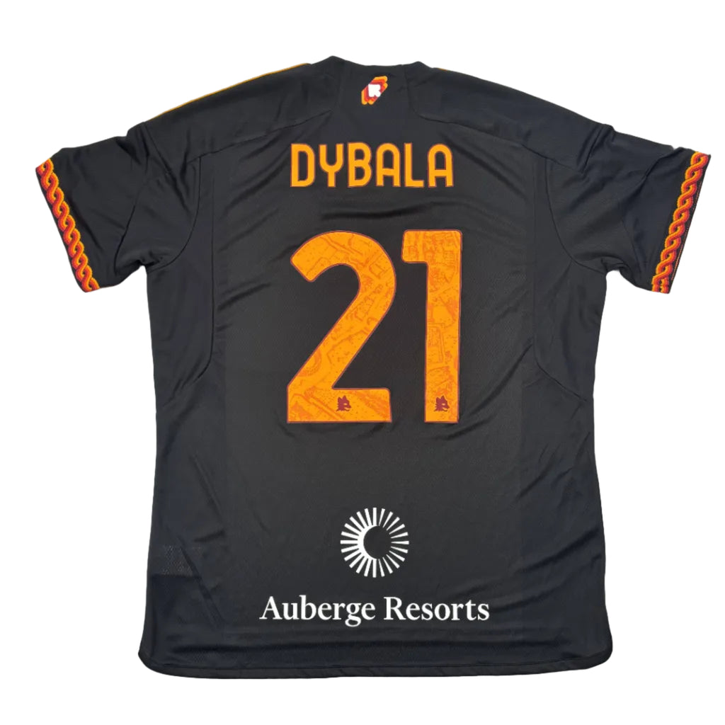 Black sports jersey with 'DYBALA' and number '21' on a round white table.