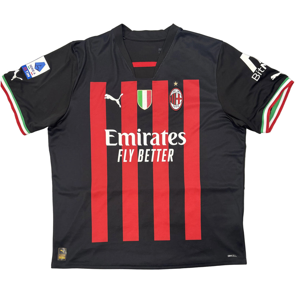 Black sports jersey with red stripes and visible branding on a white surface