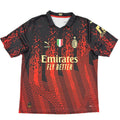 Black and red sports jersey with Emirates logo on a white surface