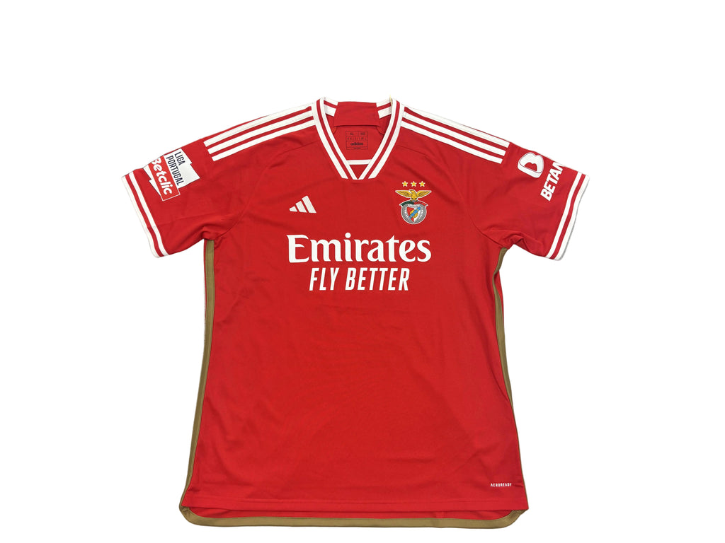 Red sports jersey with branding on a round surface