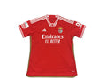 Red sports jersey with branding on a round surface
