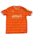 Orange sports jersey with branding on a gray surface