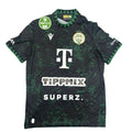 Black sports jersey with green patterns on a round white table