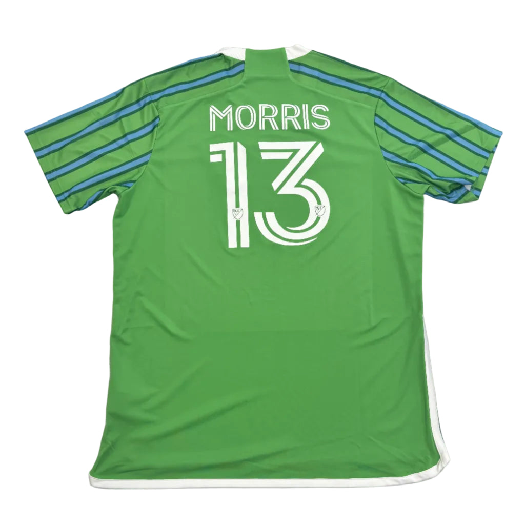 Green sports jersey with 'Morris 13' printed on it, displayed on a round gray surface.