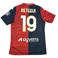 Red and navy sports jersey with 'Retegui' and number '19' on a white surface.