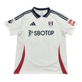 White sports jersey with red accents and visible branding on a round surface.