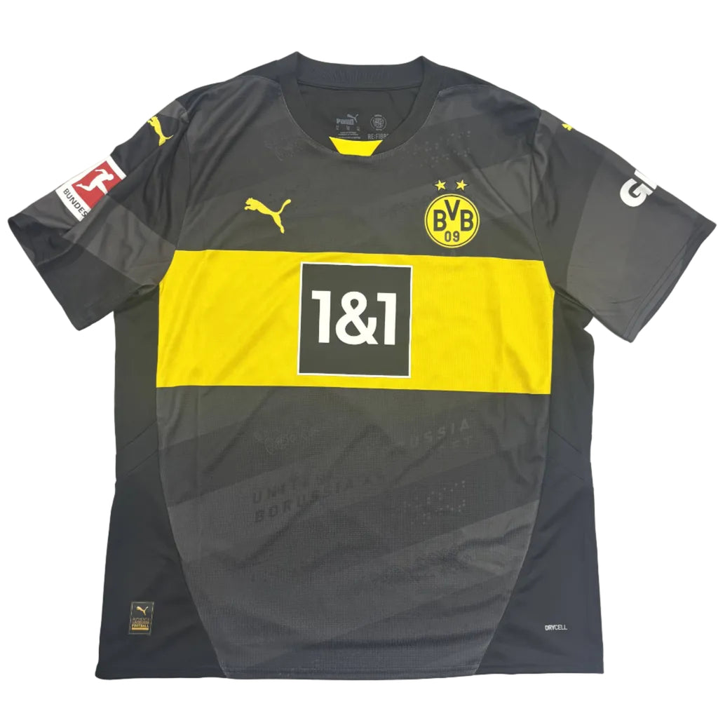 Gray and yellow sports jersey with branding on a round white table.