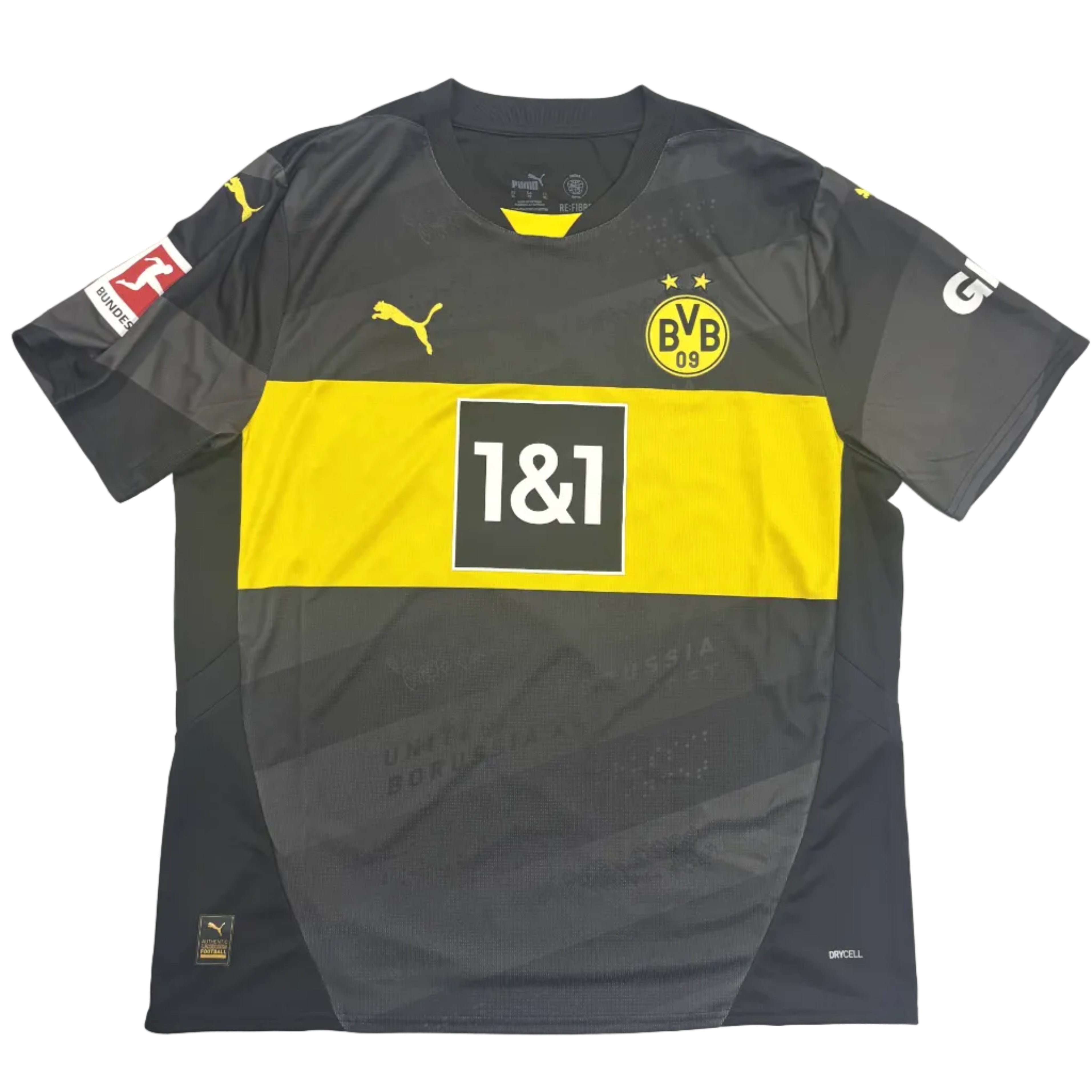 Gray and yellow sports jersey with branding on a round white table.