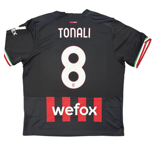 Black sports jersey with 'Tonali' and number '8', featuring 'wefox' branding, on a circular gray surface.